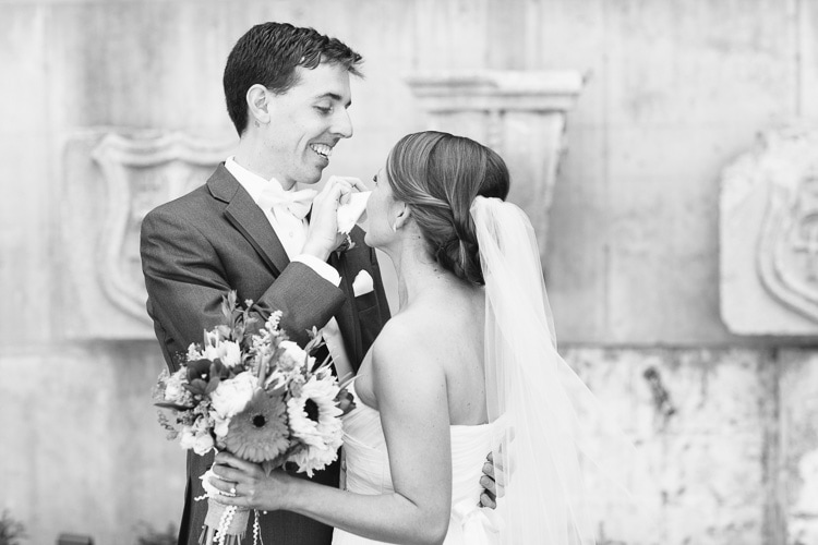 first look in the courtyard at St. Cecilia's, groom wipes away bride's tear