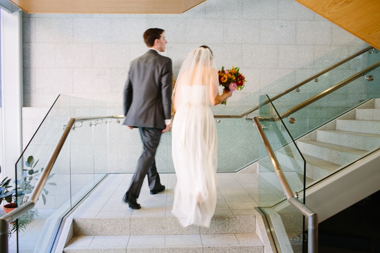 bride and groom on stairs of St. Cecilia's