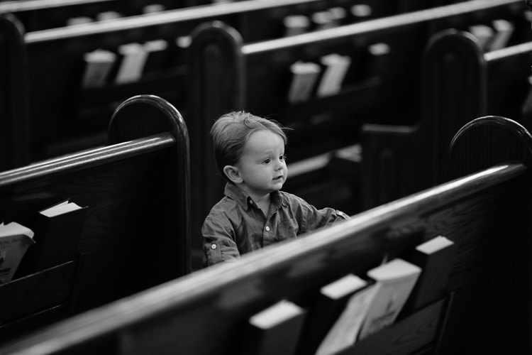 a young guest at a wedding ceremony at St. Cecilia's, Boston
