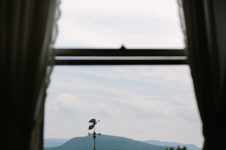 weathervane through window overlooking Berkshire mountains