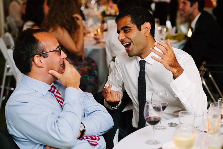 guests laugh during wedding reception