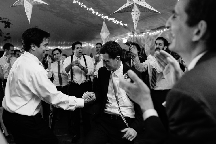 documentary image of groom dancing with friends