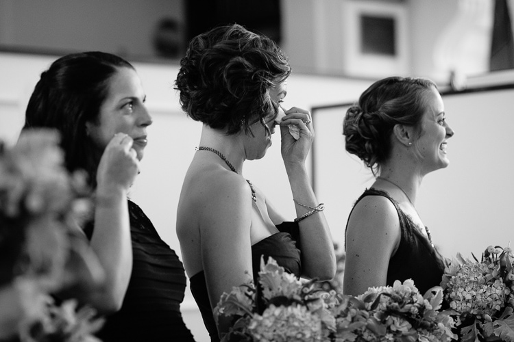 emotional Massachusetts wedding photography, bridesmaids tear up during the ceremony at the First Congregational Curch, Marion MA