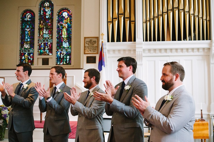 Massachusetts documentary wedding photography, groomsmen react to the first kiss at the First Congregational Curch, Marion MA
