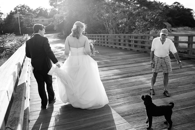 bride and groom chat with passerby on Powder Point Bridge, Duxbury, MA