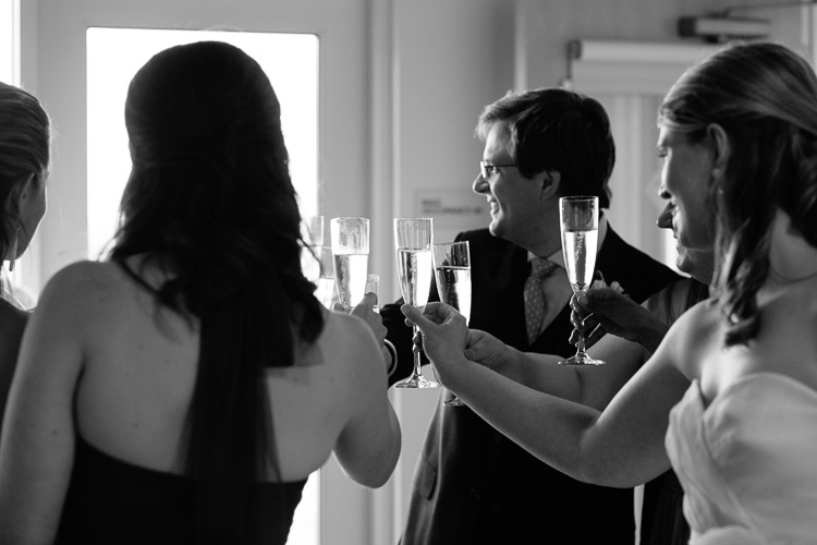 wedding party shares a toast before joining cocktail hour