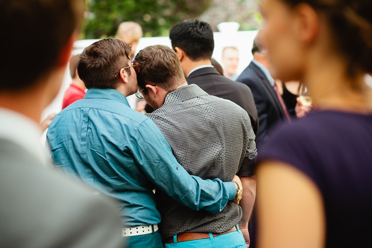 couple embraces during wedding cocktail hour