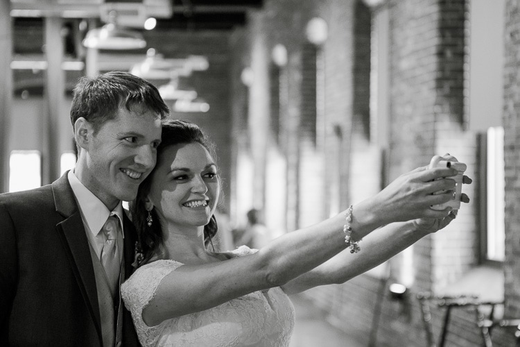 bride and groom take a polaroid selfie