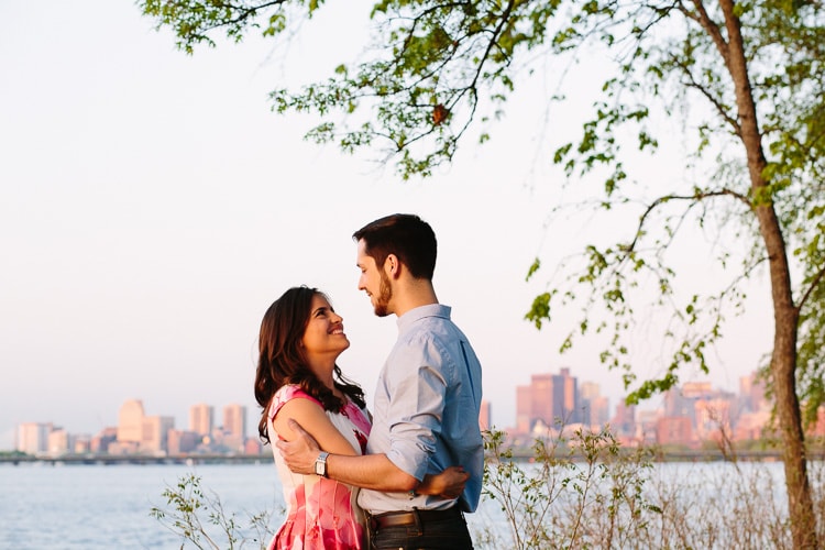Charles River engagement photography with skyline at golden hour