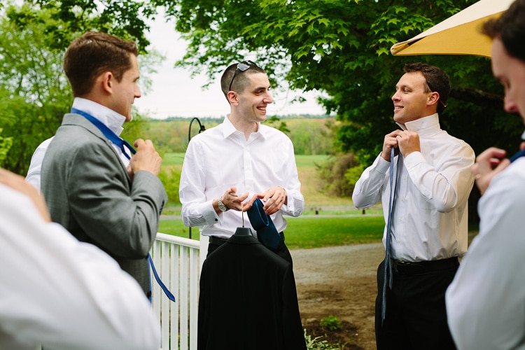 Groom and groomsmen getting ready outside at the Friendly Crossways Retreat Center
