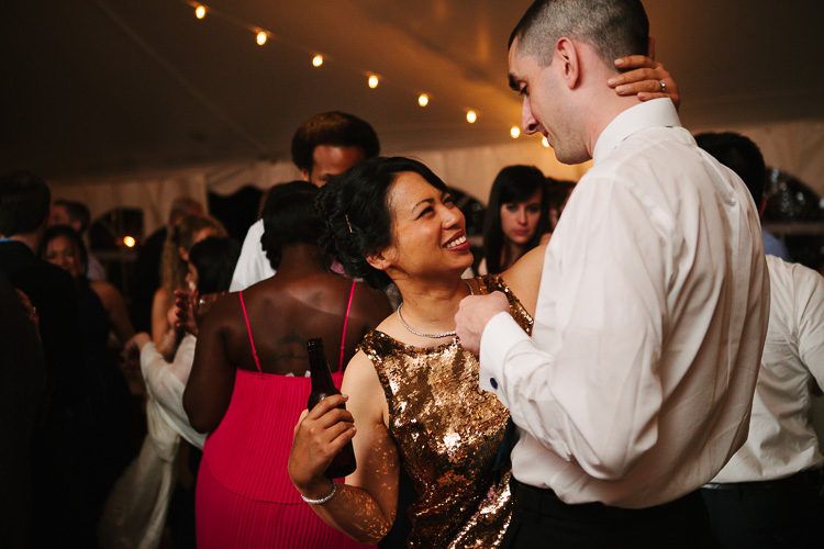 bride (in gold sequin reception dress) and groom dance at Friendly Crossways wedding