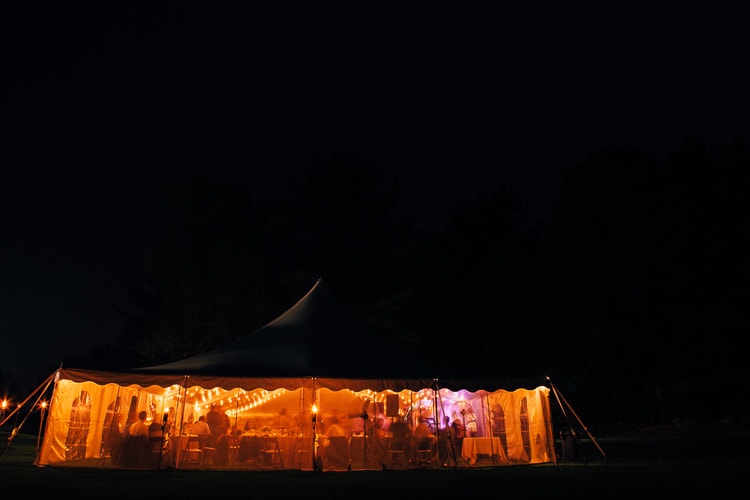 wedding tent lit up at night on the grounds of the Friendly Crossways Retreat Center