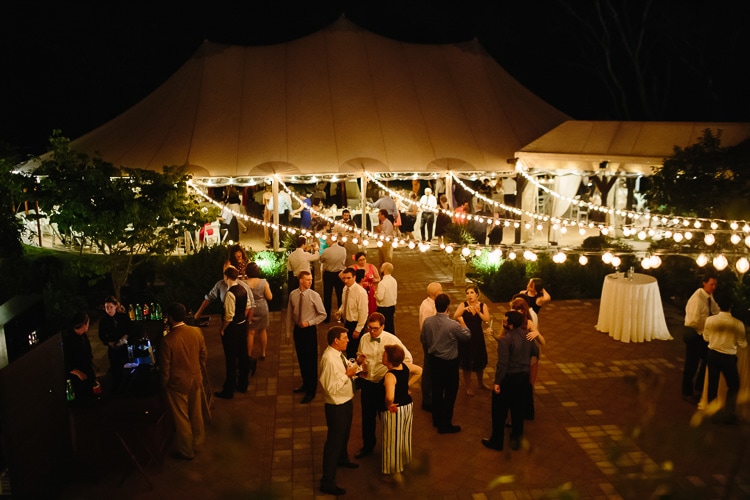 willowdale estate wedding, guests under bistro lightsguests under bistro lights in willowdale estate courtyard, photo by Kelly Benvenuto
