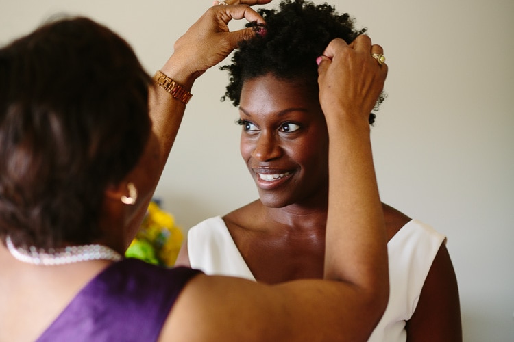 bride's mother helps her with her hair