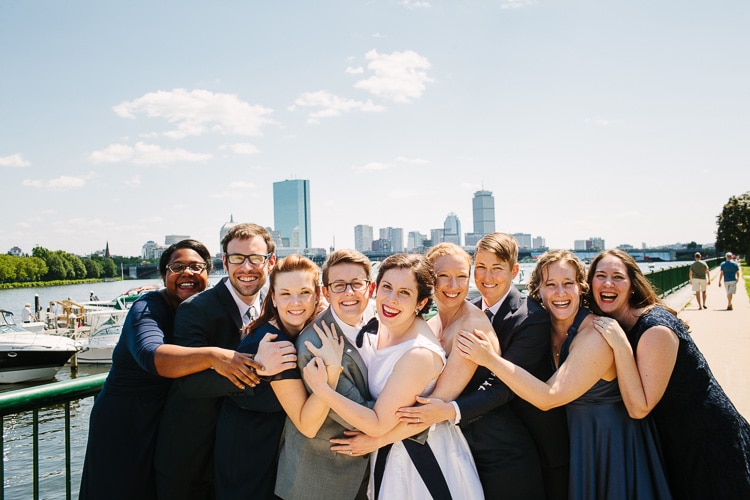 wedding party portrait along the Charles River with Boston view