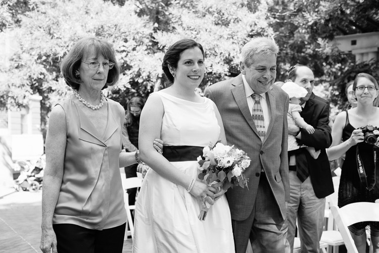 bride walks down the aisle with parents at her Cambridge Massachusetts wedding