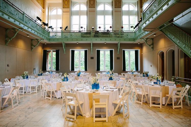 light fills the Cambridge Multicultural Arts Center, set for a wedding with blue details
