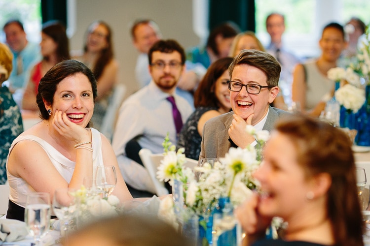 brides react to toast at their Cambridge wedding reception