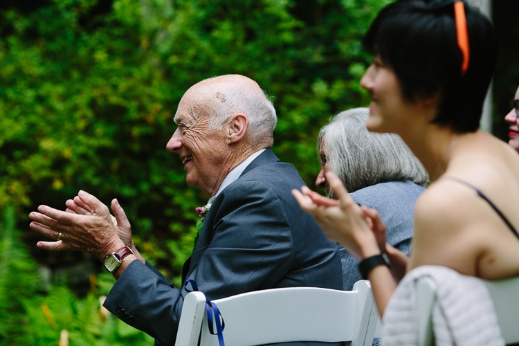 father applauds during wedding ceremony