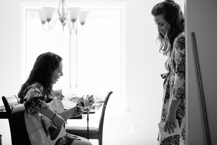 bride sings while bridesmaid plays guitar