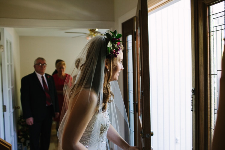 bride opens door for groom for traditional Polish parental blessing