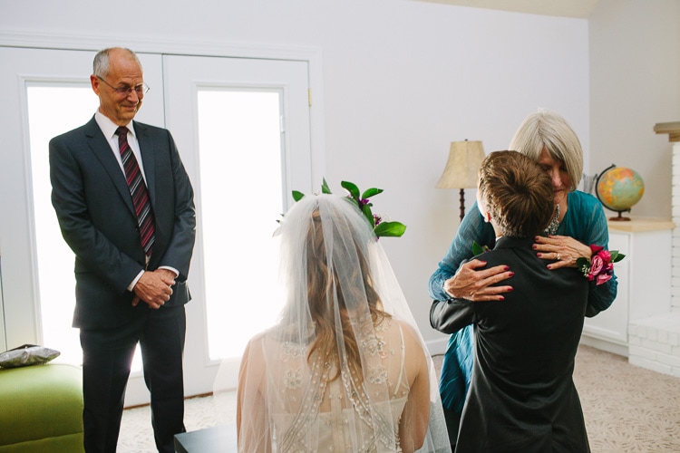 grooms parents offer blessing and hugs before the wedding ceremony