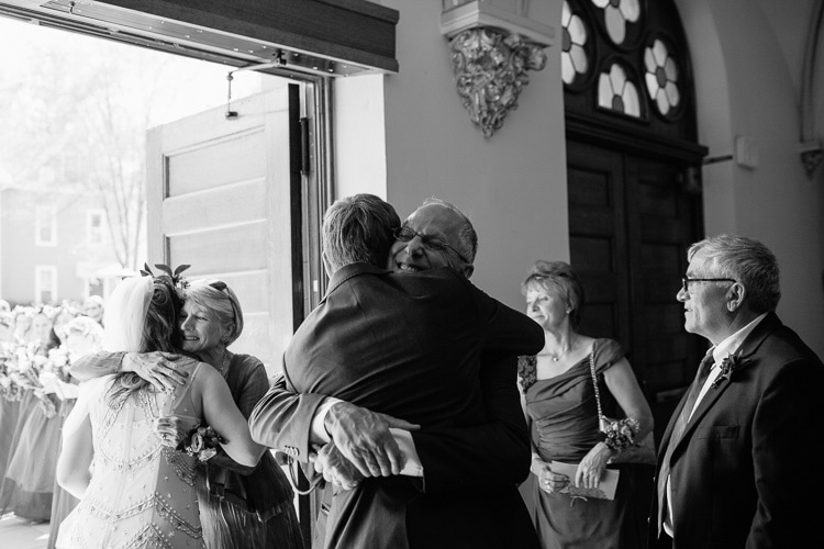 hugs for bride and groom before leaving church