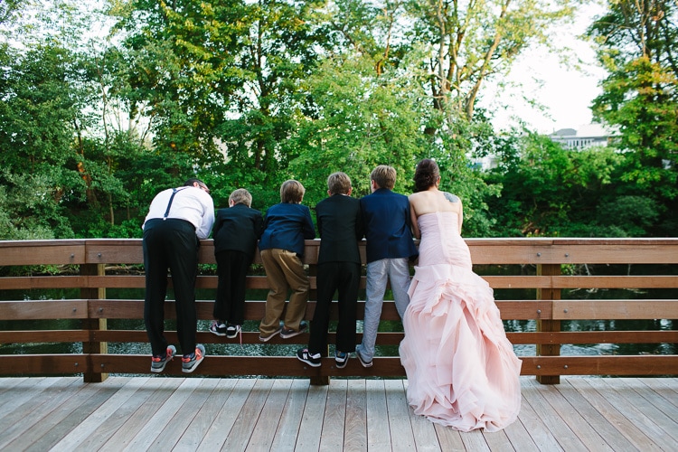 bride with the boys, looking at the river