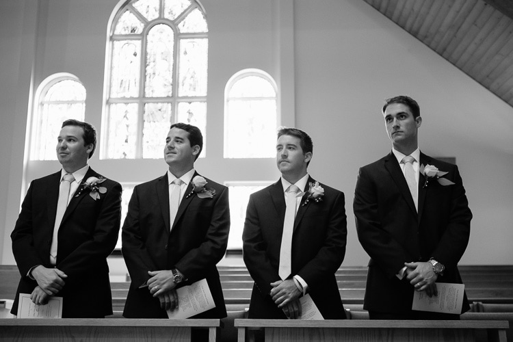 groomsmen stand during wedding ceremony
