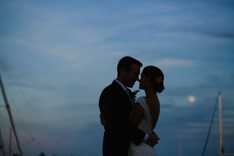romantic photo of bride and groom at the Duxbury Bay Maritime School with full moon