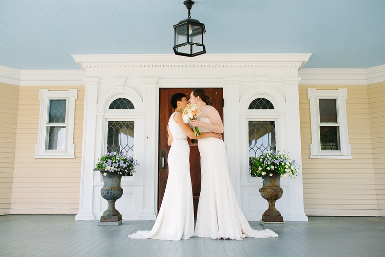 First look on the porch of the Endicott Estate in Dedham, MA. LGBT wedding photography in Boston by Kelly Benvenuto.