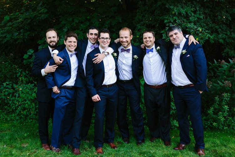 Relaxed portrait of groom and groomsmen at the Meeting House in Tiverton, RI. Photo by Kelly Benvenuto.
