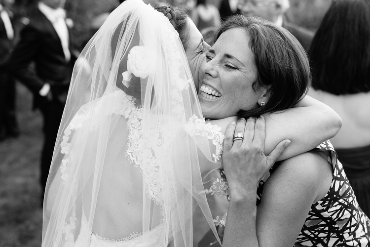 Hugs after the wedding ceremony. Emotional, documentary wedding photography by Kelly Benvenuto, serving Boston and New England.