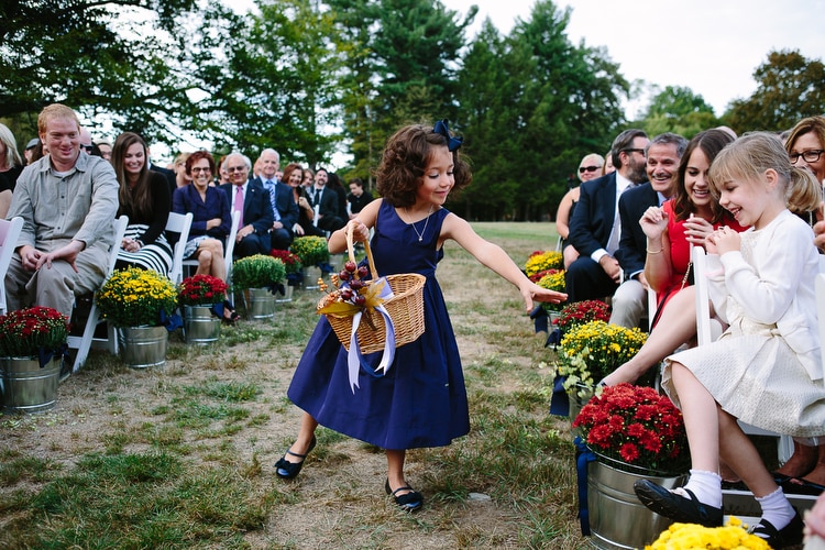 Flower girl scatters petals at the start of the wedding ceremony at Pierce House in Lincoln, MA. Boston documentary wedding photography by Kelly Benvenuto.