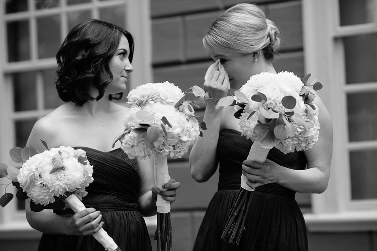 Bridesmaid tears up during wedding ceremony. Emotional wedding photojournalism in Boston by Kelly Benvenuto.