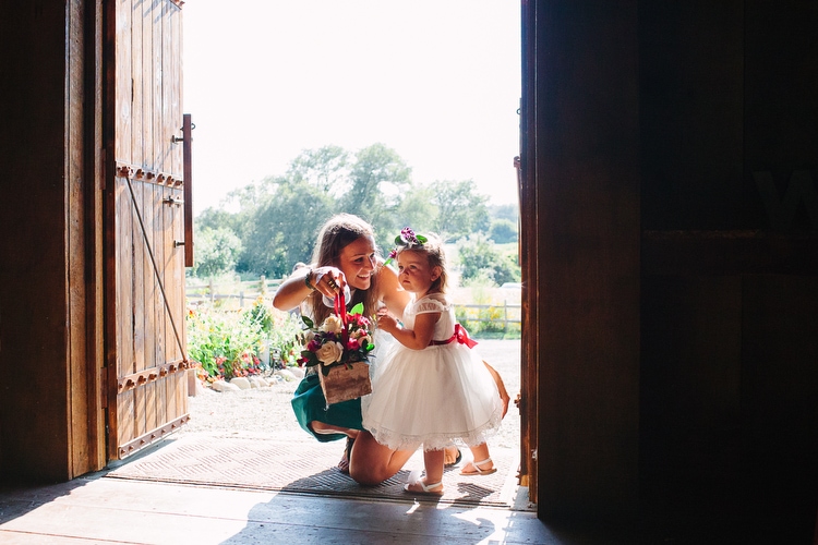Flower girl gets a pep talk before making her reception entrance. Documentary wedding photography by Kelly Benvenuto, serving Boston, New England, and beyond.