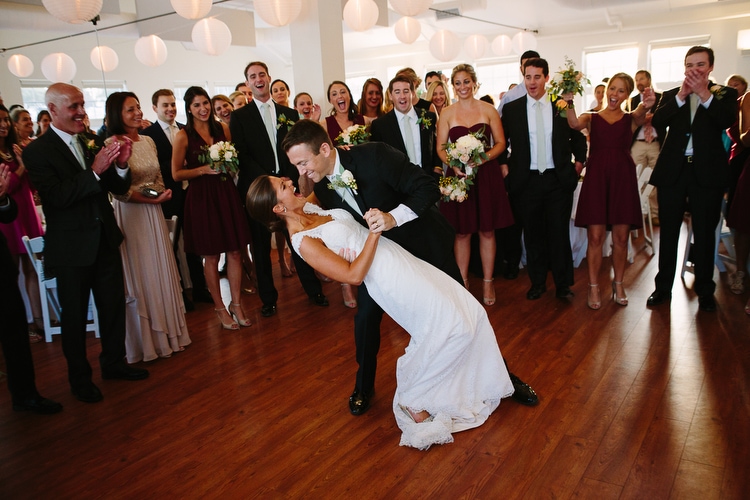 The joyful first dance of the bride and groom at the Duxbury Bay Maritime School in Duxbury, MA. Honest and emotional wedding photography by Boston wedding photographer Kelly Benvenuto.