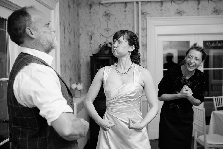 Silly bride with wedding guests. Candid wedding photography in Boston by Kelly Benvenuto.