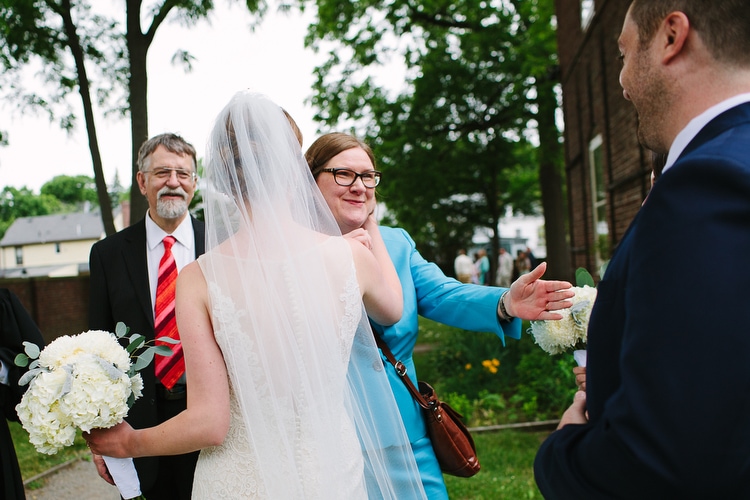 Bride and groom greet parents after the wedding ceremony. Honest, emotional wedding photography by Kelly Benvenuto, in Boston and New England.