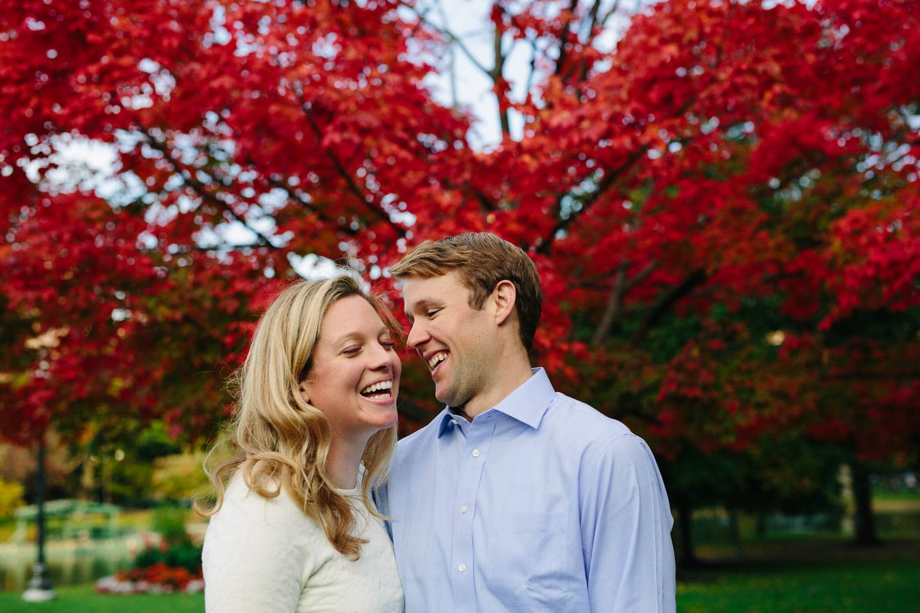 Fall Boston Public Garden engagement photo with brilliant red foliage