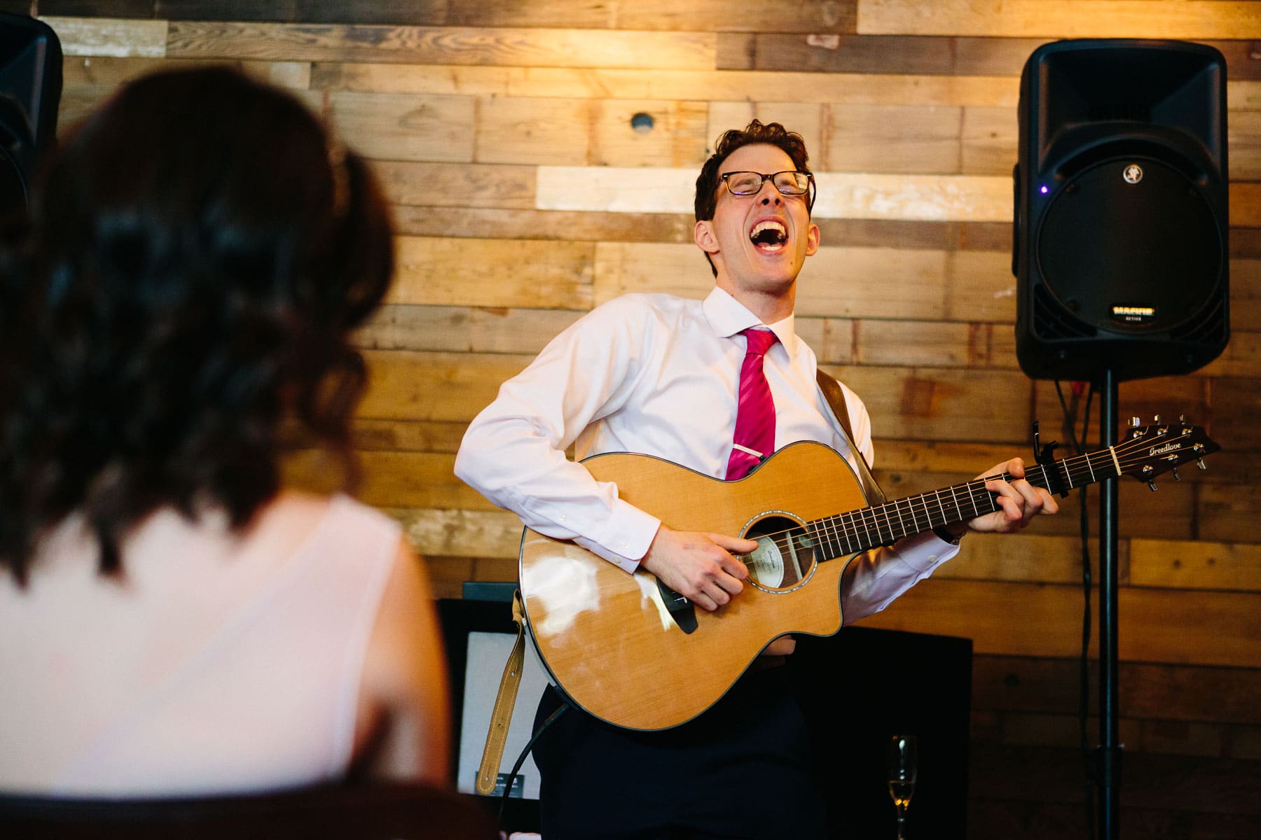 groom sings to bride during wedding reception at Barcelona Wine Bar, Brookline