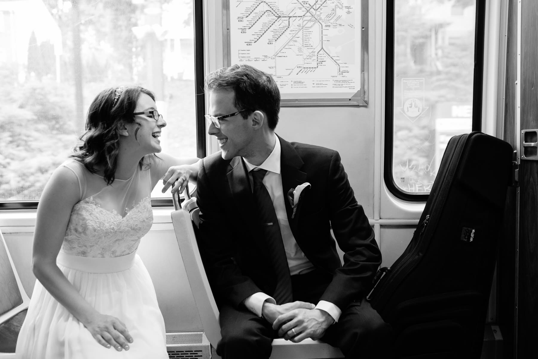 bride and groom ride the T after their Brookline wedding