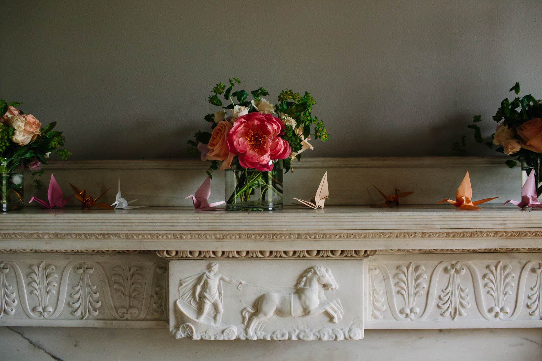flowers and paper cranes on the mantel in the Lyman Estate ballroom