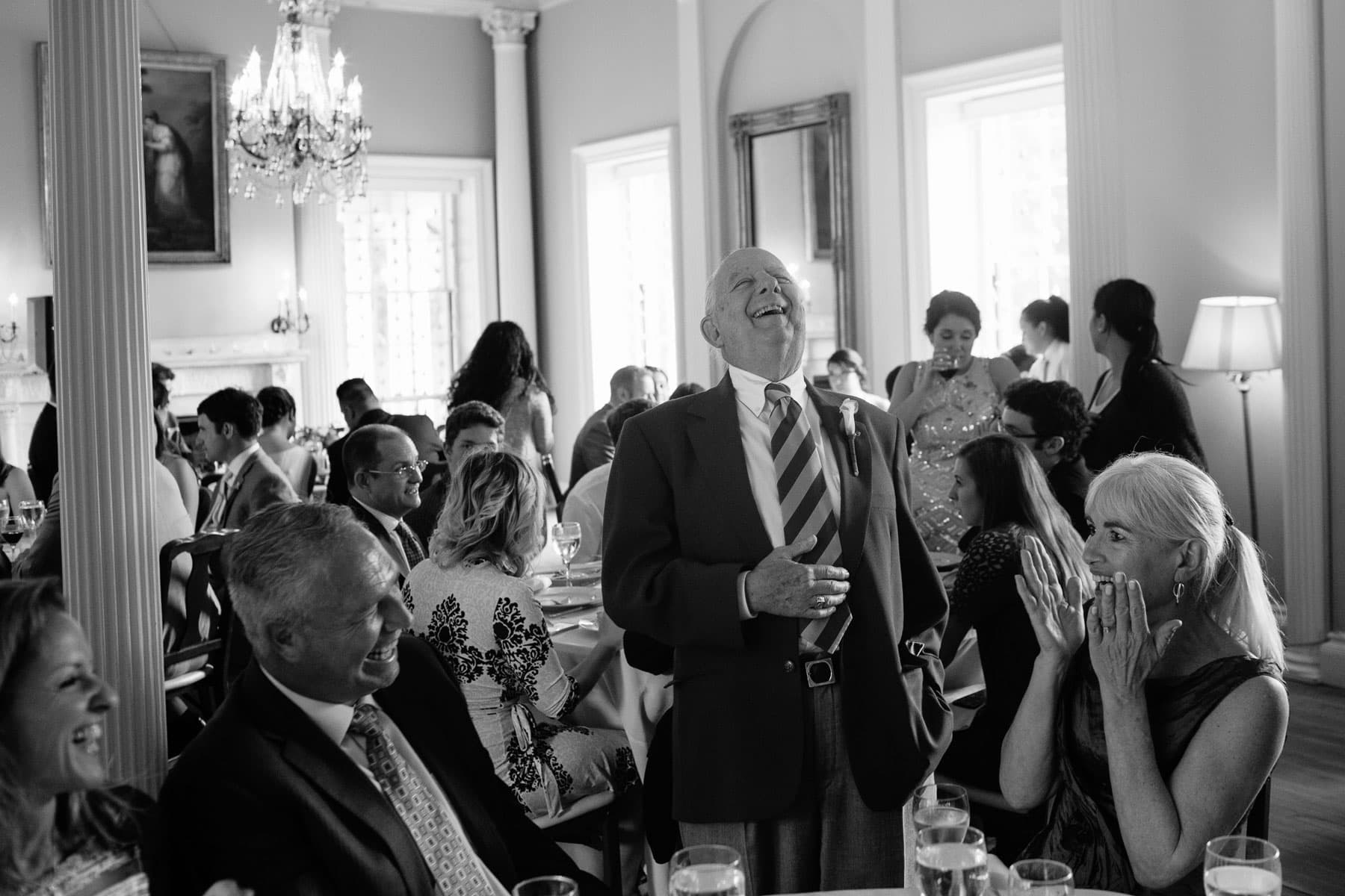 guests laugh during wedding luncheon at the Lyman Estate