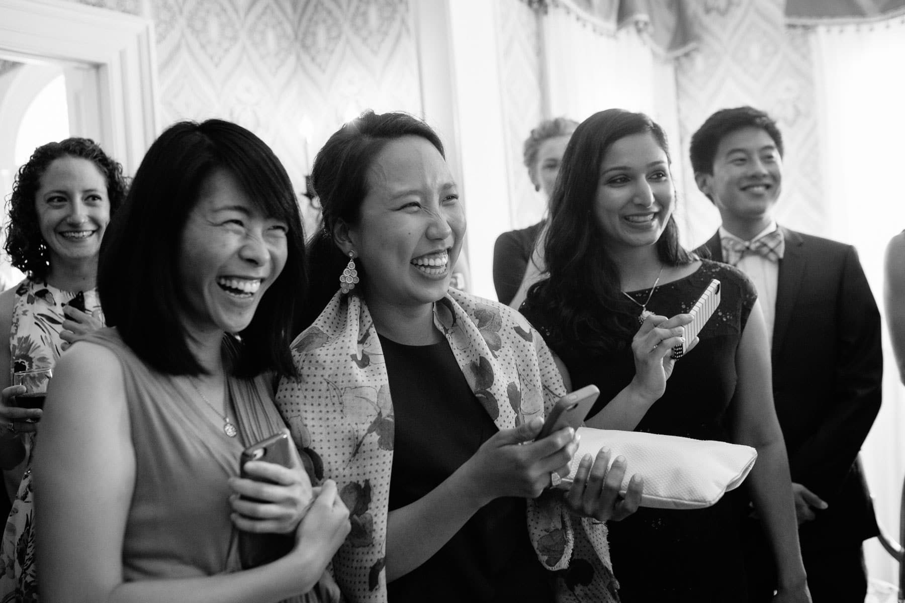 guests laugh during wedding toasts