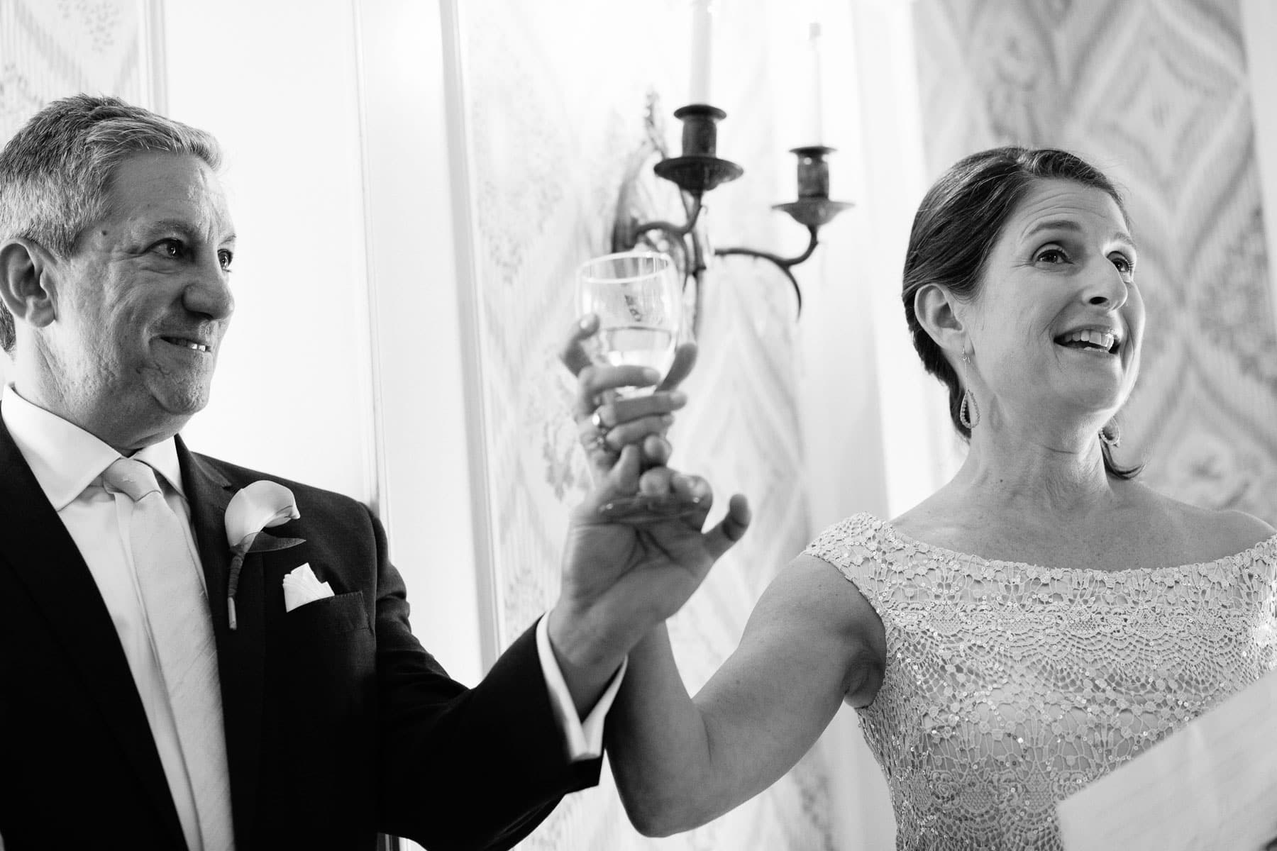 parents raise a glass in toast to bride and groom at the Lyman Estate