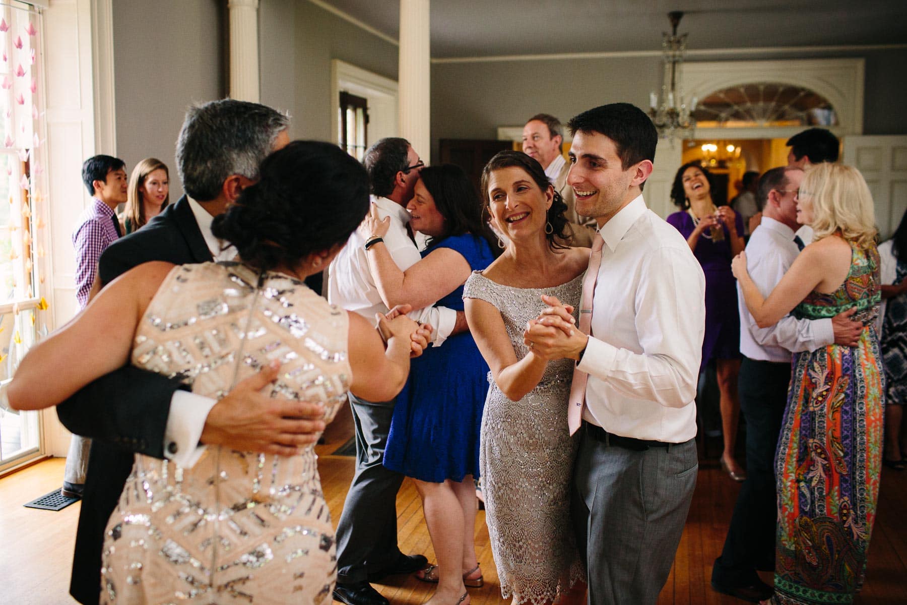 groom shares a dance with his mom in the ballroom of the Lyman Estate