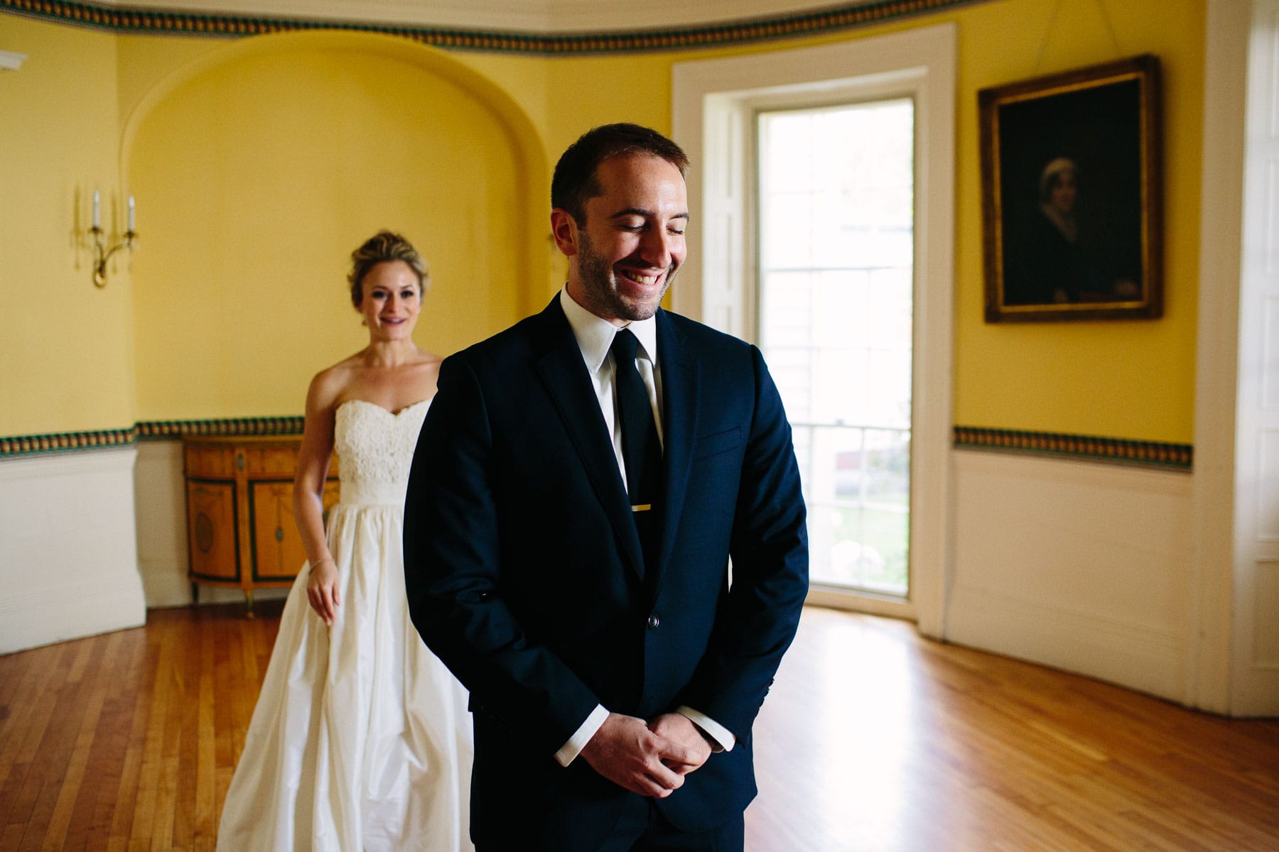 bride and groom first look in yellow salon at Lyman Estate