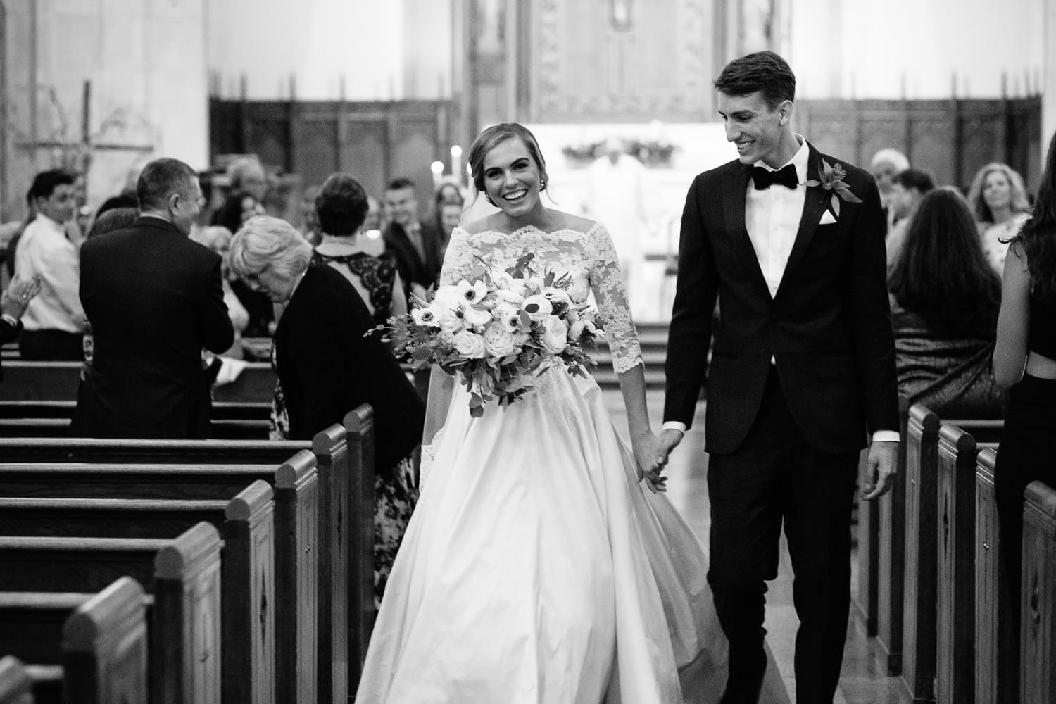 bride and groom walk up the aisle at St Ignatius, Boston College wedding